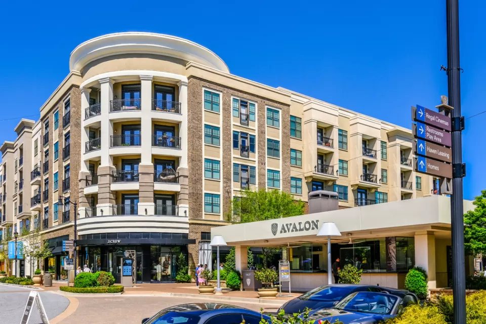 A mid-rise building with retail and apartments. A car port announces the name of the development: Avalon.